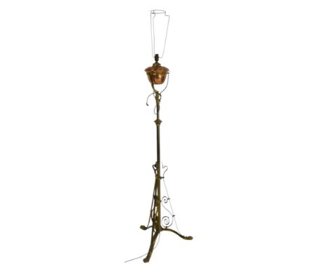 An early 20thC copper and brass Art Nouveau style adjustable floor lamp, decorated with scroll support to the tubular column,