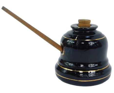 A Victorian Williams black pottery ink pot, registration number 331808, with wooden stopper and a quill, the ink pot 10cm hig