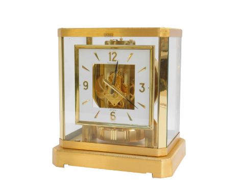 A Jaeger leCoultre glass and brass cased Atmos clock, with a square white painted dial bearing batons and Arabic numerals at 