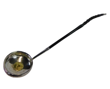 A George III silver toddy ladle, with a twisted whale bone handle, the bowl inset with a gold plated George III 1787 shilling