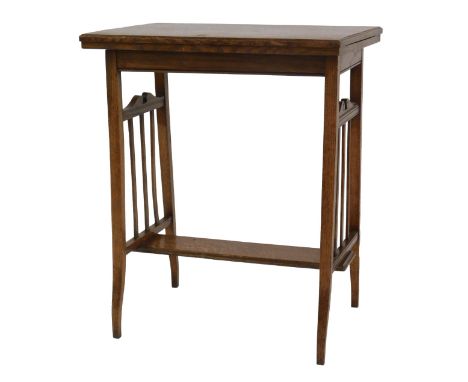 An Edwardian oak card table, the rectangular folded top enclosing a baize lined interior, on tapering supports with flat unde