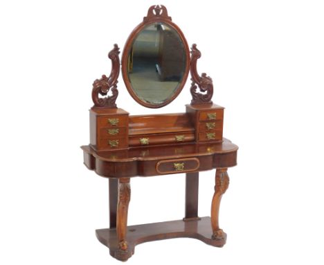 A Victorian mahogany Duchess dressing table, the top with an oval mirror plate, on carved supports with two sets of three tri