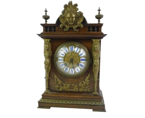 A late 19thC French mahogany cased and brass mounted mantel clock, the embossed brass circular dial with raised white enamel 