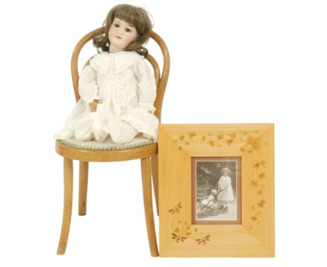 An Armand Marseilles bisque head doll, wearing a broderie anglaise dress, number 390 A8M, 60cm long, together with a bentwood