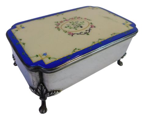 A Victorian silver and enamel casket, of rectangular canted form, the enamelled lid decorated with flowers within a gilt and 