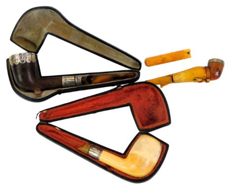 A cased wooden pipe with silver mounts, a Meerschaum pipe with a silver collar, and a novelty Meerschaum pipe carved as a fem