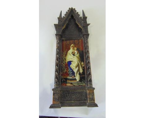 An unusual 19th century continental ceramic panel with painted and gilded finish, showing the Madonna and Child seated, with 