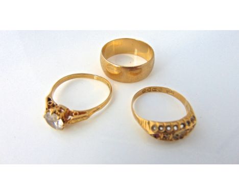 A 9ct gold wedding band, 4.8g, size T; an 18ct gold ring, set with a cubic zirconia, size S; and an 18ct gold ring, set with 