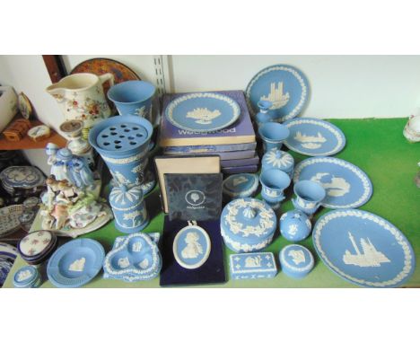 A collection of Wedgwood blue ground jasperwares including a vase with flared rim complete with flower holder, four further v