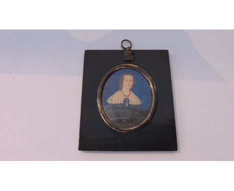 A portrait miniature of a lady dressed in 18th century fashion within an ebonised square frame with crown and leaf decoration