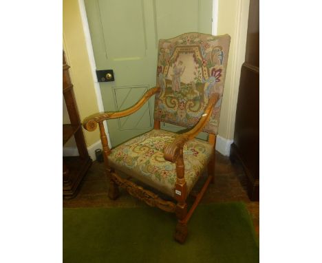 A late 19th century continental beechwood elbow chair with carved and pierced rail and handworked tapestry seat and back