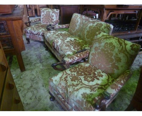 An exceptionally small sofa and two matching armchairs with mahogany shepherd's crook shaped arms, raised on short pad feet, 