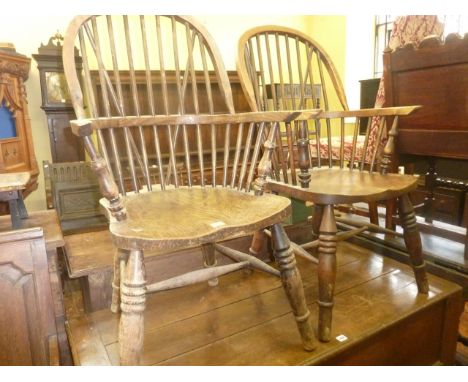 A pair of late 19th century Windsor comb back elbow chairs in mixed woods including elm, ash, and beech