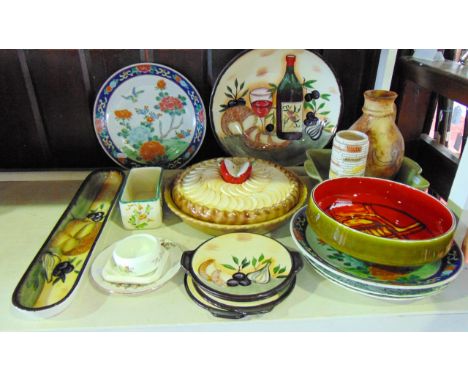 A Poole Pottery bowl with red, yellow and orange abstract decoration to the interior and olive green glaze to the exterior, a