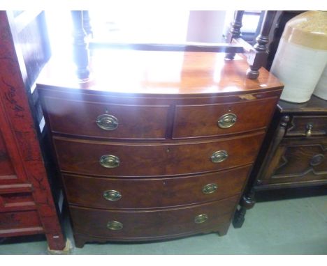 An early 19th century mahogany bow fronted chest of three long and two short drawers, with caddy top, string inlaid detail an