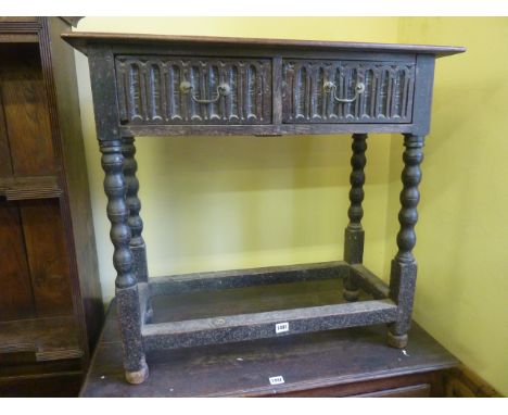 An old English oak side table fitted with two frieze drawers raised on bobbin moulded supports, 80 cm wide