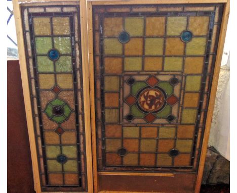 A Victorian stained glass panel of rectangular form set centrally with a circular plate detailing a songbird on a foliate spr