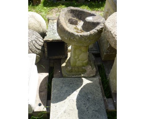A small weathered cast composition stone 2-sectional bird bath, a faux terracotta square cut pedestal with relief detail, a w