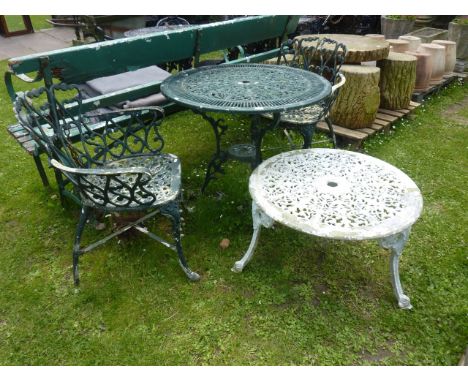 A painted cast aluminium garden terrace table of circular form with decorative pierced scrolling acanthus top, raised on swep