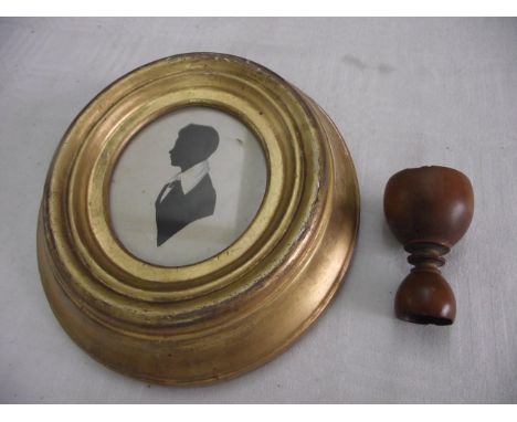 A 19th century miniature silhouette portrait of oval form showing a bust length profile study of a boy in white collar, remai