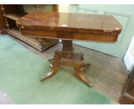 A Regency mahogany D end fold over top card table raised on a square cut and tapering column, platform plinth and four sabre 