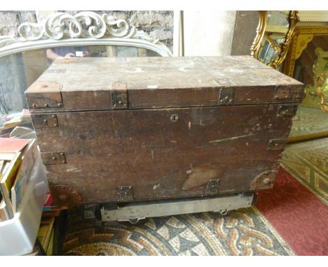 A 19th century stained pine box/trunk of rectangular form with hinged lid and iron reinforced straps, the internal lid bearin