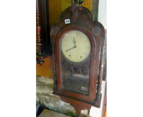 A mid 19th century American wall clock with bracket base, turned column supports and eight day striking movement with fleur-d