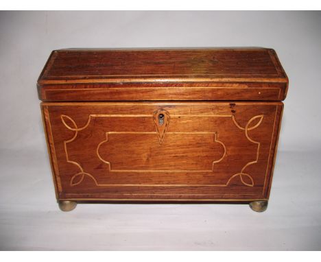 A Regency tea caddy with canted arched lid in mixed veneers with banded borders, inlaid escutcheon and further banded detail 