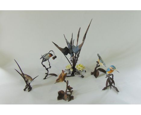 A collection of six well detailed bisque ceramic and cast metal groups of birds including a swooping swallow, a kingfisher, w