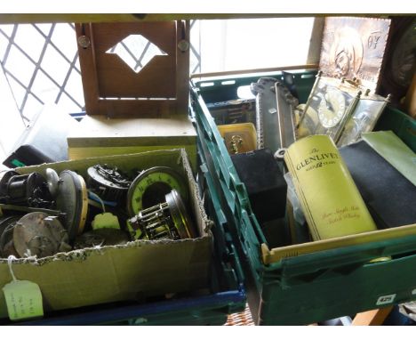 A box containing a miscellaneous collection of clocks and clock spares including pendulums, weights, hand tools, clamps, move