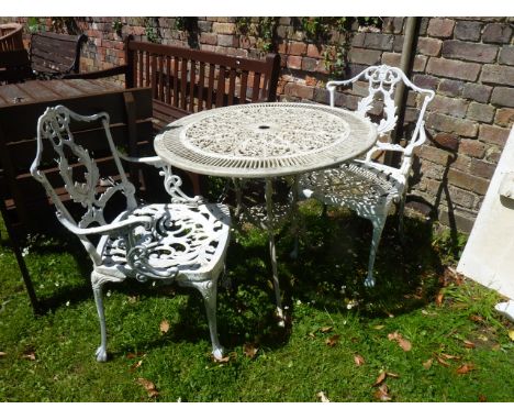A painted cast aluminium garden terrace table with decorative pierced circular top raised on swept tripod supports, together 