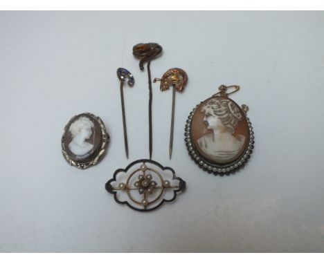 AN EDWARDIAN 9CT GOLD SEED PEARL BROOCH, together with three gilt and yellow metal stick pins and two cameo pendant brooches 