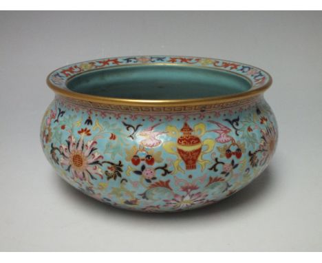 A CHINESE CERAMIC LOW BOWL A/F, enamel decoration upon a pale blue ground, gilding to the rim, character mark to base Dia. 20
