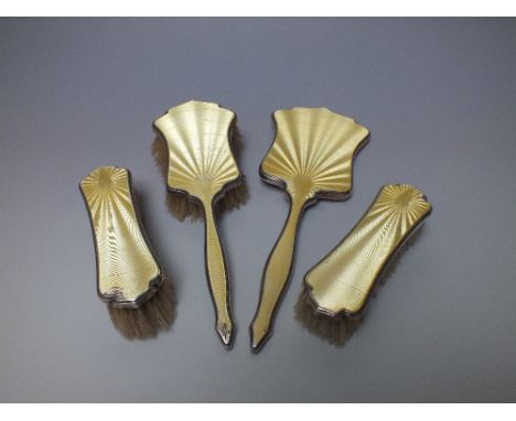 A HALLMARKED SILVER AND GUILLOCHE ENAMEL FOUR PIECE DRESSING TABLE SET, comprising a hair brush, hand mirror and two valet br