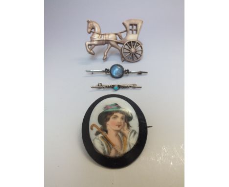 AN OVAL WHITBY JET BROOCH WITH INSET CERAMIC PORTRAIT PANEL, together with a silver butterfly wing bar brooch, another silver