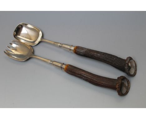 AN IMPRESSIVE PAIR OF ANIMAL HORN SILVER HANDLED SALAD SERVERS LONDON 1892, having inlaid silver disc finial's engraved with 