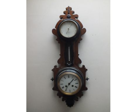 A MAHOGANY AND EBONISED WALL CLOCK BAROMETER BY J.J. WAINWRIGHT &amp; CO - BIRMINGHAM, the circular clock dial with Roman num
