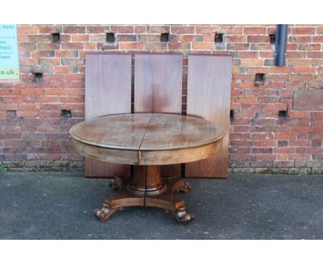 A LARGE 19TH CENTURY MAHOGANY EXTENDING PEDESTAL DINING TABLE, the heavy top supported on a single circular tapering pedestal