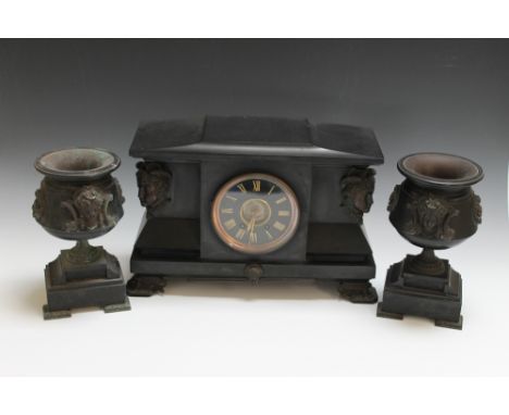 A LATE 19TH / EARLY 20TH CENTURY BLACK SLATE CLOCK GARNITURE, the clock with black enamel dial and gilt Roman numerals, flank