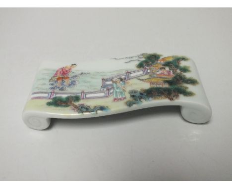 A CHINESE SCHOLARS / ARTIST CERAMIC PEN REST, supported on scrolling feet, enamel painted decoration depicting figures and fo