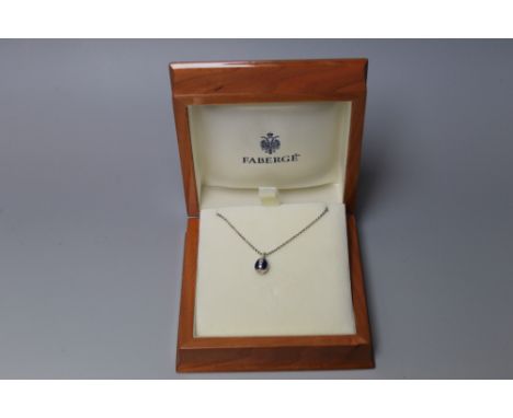 FABERGE - AN 18 CARAT WHITE GOLD &amp; BLUE GUILLOCHE ENAMEL PENDANT, the teardrop shaped pendant decorated in alternating li