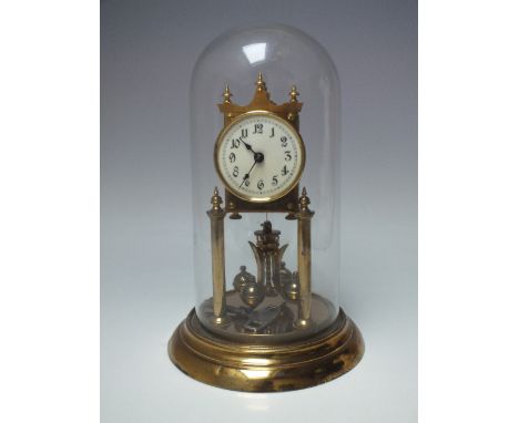 A 20TH CENTURY BRASS ANNIVERSARY CLOCK UNDER GLASS DOME, numbered 159860, overall H 30.5 cmCondition Report:Complete with key
