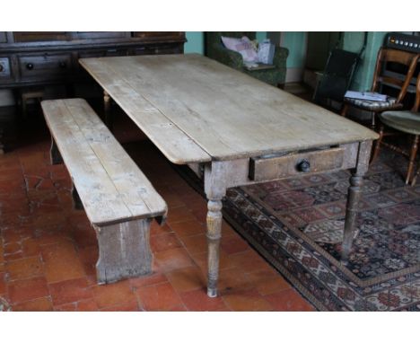 A LARGE FARMHOUSE PINE SCRUB TOP KITCHEN TABLE, with a single frieze drawer to one end, small dropleaf to one side, raised on