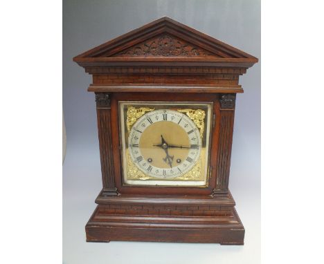A WINTERHOLDER AND HOFMEIER OAK CASED MANTEL CLOCK OF ARCHITECTURAL FORM, the square brass dial with silvered chapter ring an
