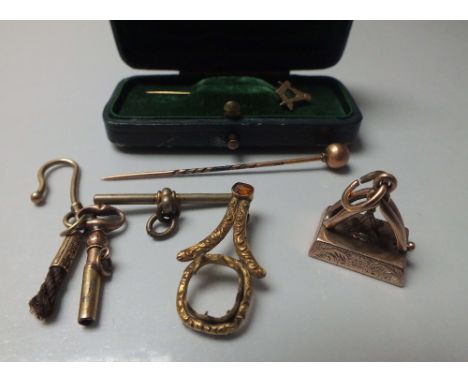 A 9CT GOLD FOB WITH MASONIC INSIGNIA, together with a gold Masonic stick pin, another gold stick pin and a pocket watch key &