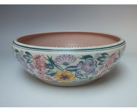 A LARGE POOLE POTTERY DECORATIVE BOWL, decorated with a floral border, impressed mark to base and incised '667' and painted d