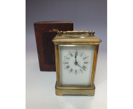 A FRENCH GONG STRIKE BRASS CARRIAGE CLOCK WITH LEATHER CASE, the enamel face with Roman numerals and outer numeral minute dia