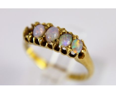 18 ct gold ring set with good opals, one opal missing, size M. 2.9g