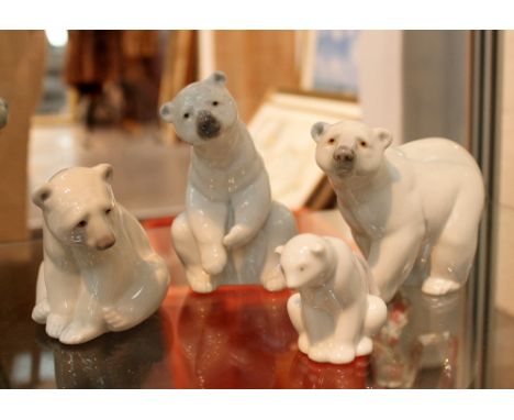 Three Lladro polar bear figures and one Nao example