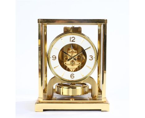 Jaeger LeCoultre Atmos clock, the white chapter ring enclosing a skeletonised centre, serial number 237646, within a brass gl